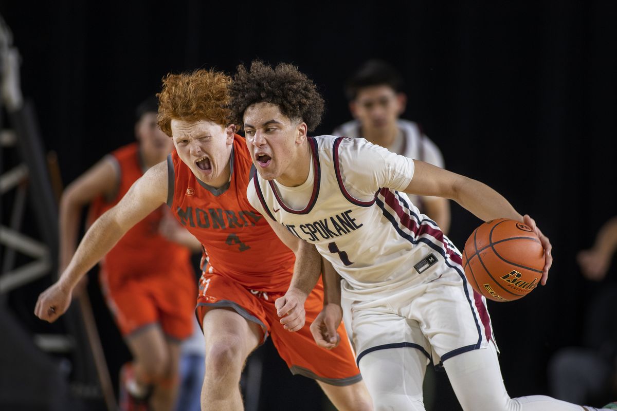 Mt. Spokane’s Jaden Ghoreishi is fouled by Monroe’s Tate Hammerquist after a steal in Wednesday’s State 3A play in Tacoma. (Patrick Hagerty)