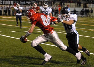 
Ferris' Jared Karstetter gets a handful of facemask as Gonzaga Prep's Landon Cooney tries to drag him down. 
 (Jed Conklin / The Spokesman-Review)