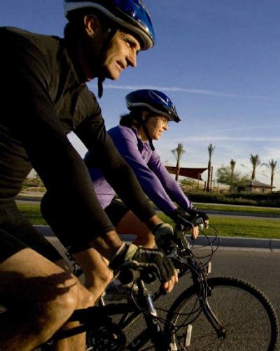 
Soon-to-be-retirees, Jose Hinojosa and his wife Kady Hinojosa ride their bicycles through their neighborhood in Peoria, Ariz. The Hinojosas are planning a September retirement and hope to take advantage of something Shea Home's Trilogy retirement division emphasizes: an active lifestyle. 
 (Associated Press / The Spokesman-Review)