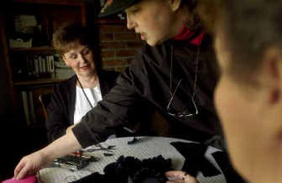 Founding members of Sandpoint's Lost in the 50's, from left, Sally Transue, Carolyn Gleason and Betty O'Donnell work on ribbons on Thursday for the event.
(Kathy Plonka / The Spokesman-Review)