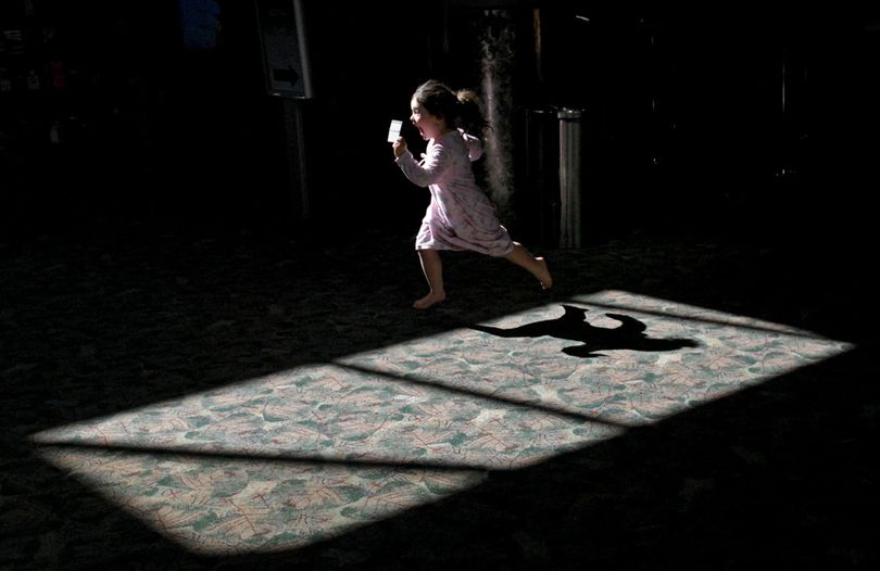 ORG XMIT: NVREN101 Lauren Dorris, 3, of Anchorage, Alaska runs to show her mother a trading card of the airport police dog giving to her by an airport police officer after she petted the dog at the Reno-Tahoe International Airport in Reno, Nev. on March 10, 2009.(AP Photo/Reno Gazette-Journal, Andy Barron) (Andy Barron / The Spokesman-Review)