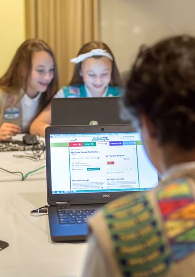 Scouts Olivia and Isabella practice selling cookies on one of two new digital platforms, in this undated photo. Girls Scouts of the USA is allowing sales using a mobile app and personalized websites. (Associated Press)