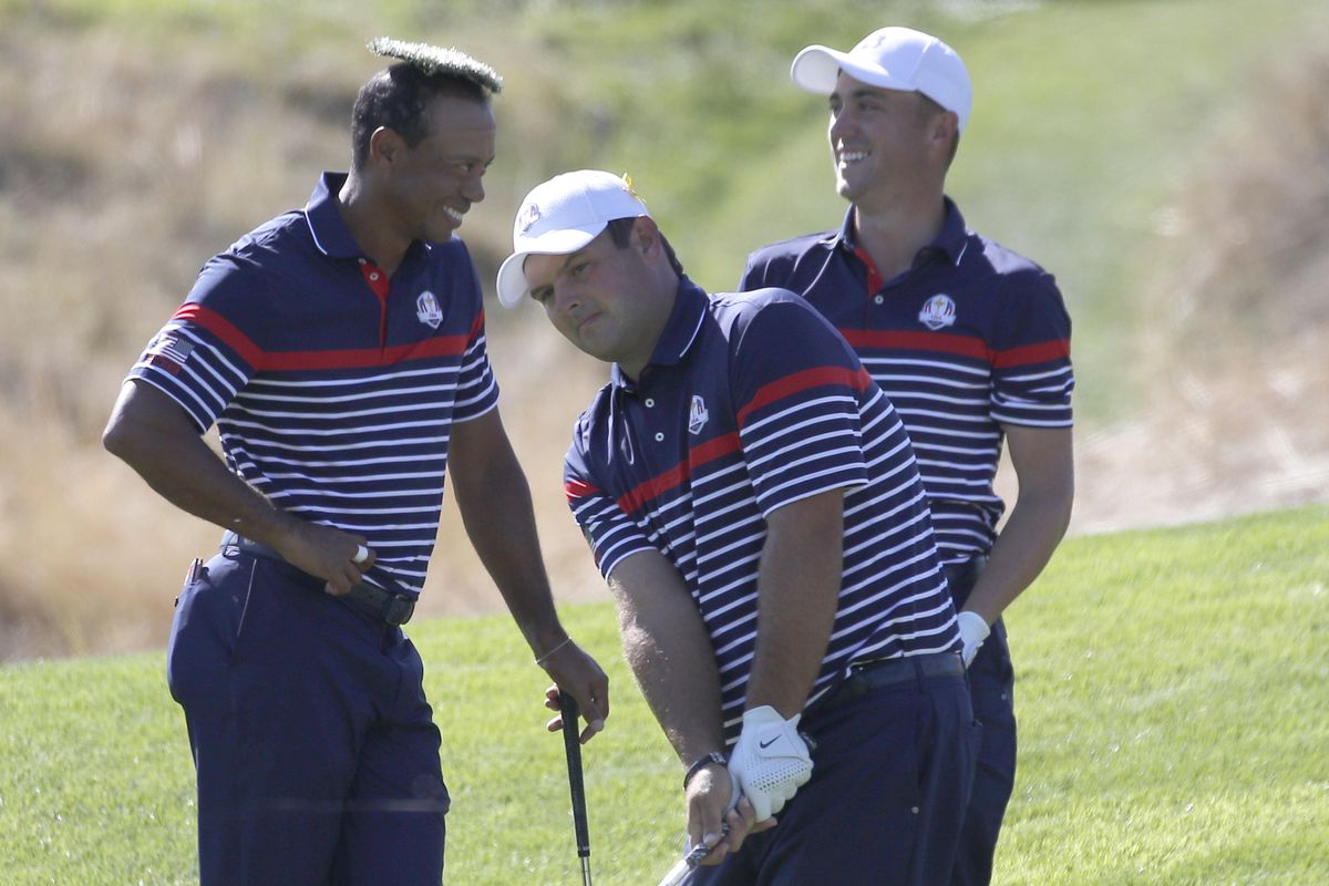 Tiger Woods of the U.S. places the cover of a water sprinkler as he jokes with Patrick Reeds, center, and Jordan Spieth, right, during a practice round of the Ryder Cup at Le Golf National in Saint-Quentin-en-Yvelines, outside Paris, France, Thursday, Sept. 27, 2018. The 42nd Ryder Cup will be held in France from Sept. 28-30, 2018 at Le Golf National. (Francois Mori / Associated Press)