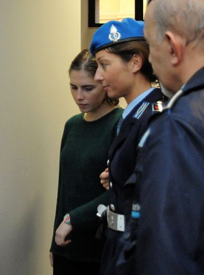 Amanda Knox, left, is escorted by penitentiary police officers after a hearing in Perugia, Italy, Monday, Nov. 8, 2010.  (Stefano Medici / Associated Press)