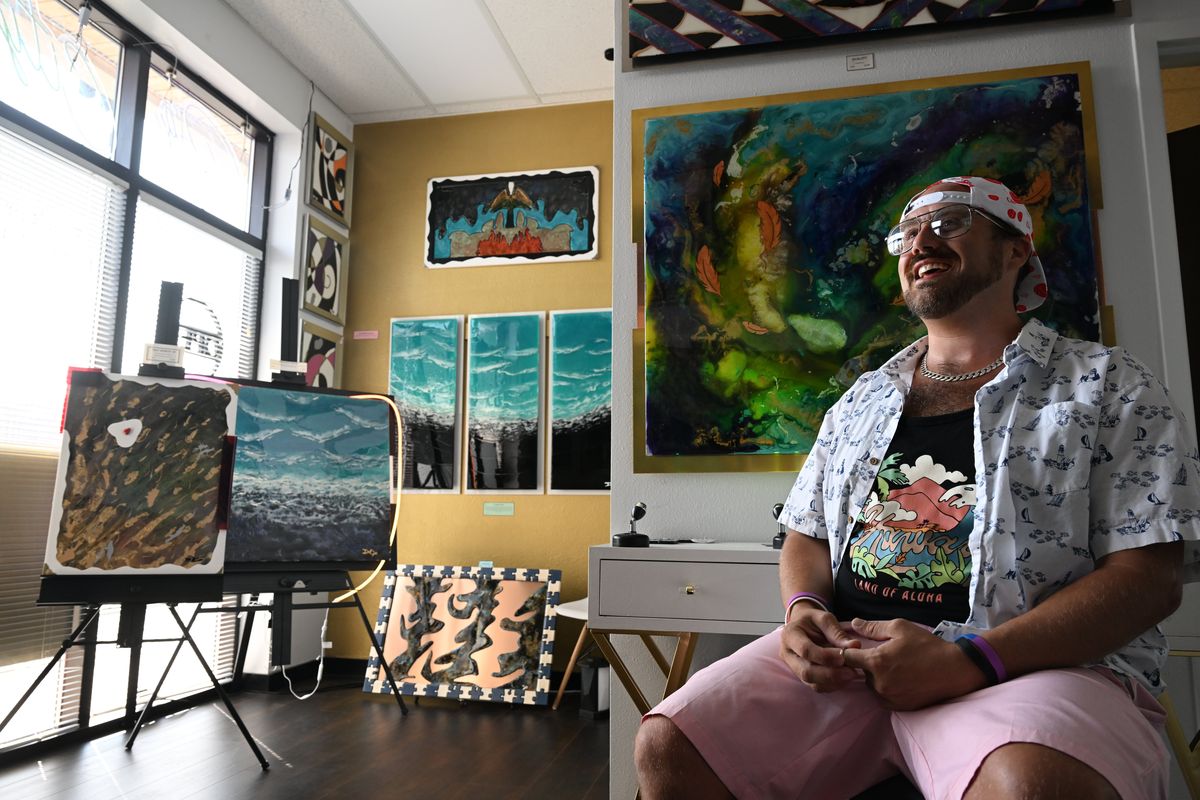 Dylan Lipsker sits Monday in his new studio and gallery he has called Big City Art, at 164 S. Washington St., in Spokane.  (Jesse Tinsley/THE SPOKESMAN-REVIEW)