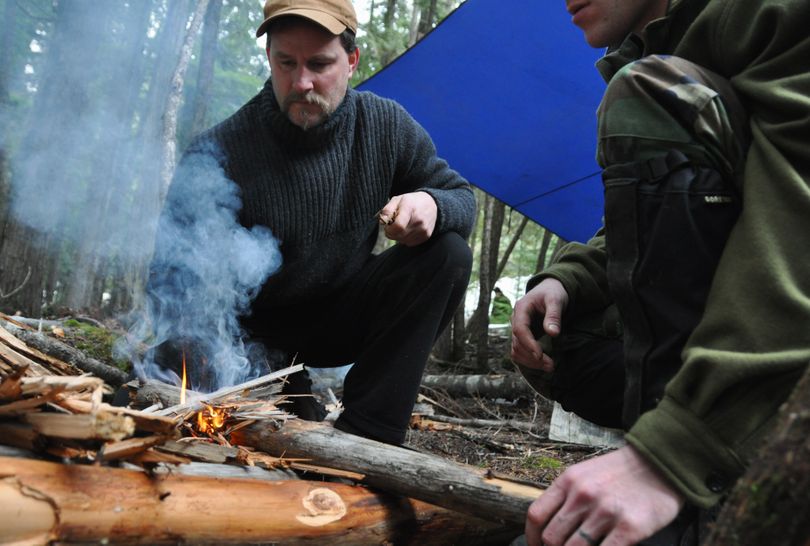 After a seminar on building a fire in wet conditions, Adam Dewey of Sandpoint applies the techniques to stoke a blaze on Feb. 1, 2010, during a misty morning search and rescue team exercise at Priest Lake State Park. The instructor for this group of students was Nick Weber of the Survival School at Fairchild Air Force Base.  The next photos follow Weber's progression for making a life-saving fire in what some people might consider hopeless conditions. (Rich Landers)