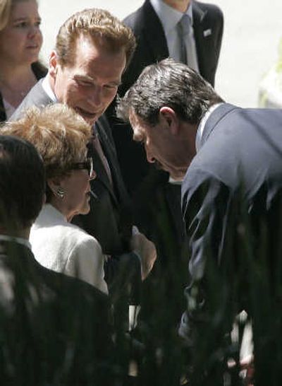 
Arnold Schwarzenegger and Tom Selleck assist Nancy Reagan after the service. Associated Press
 (Associated Press / The Spokesman-Review)