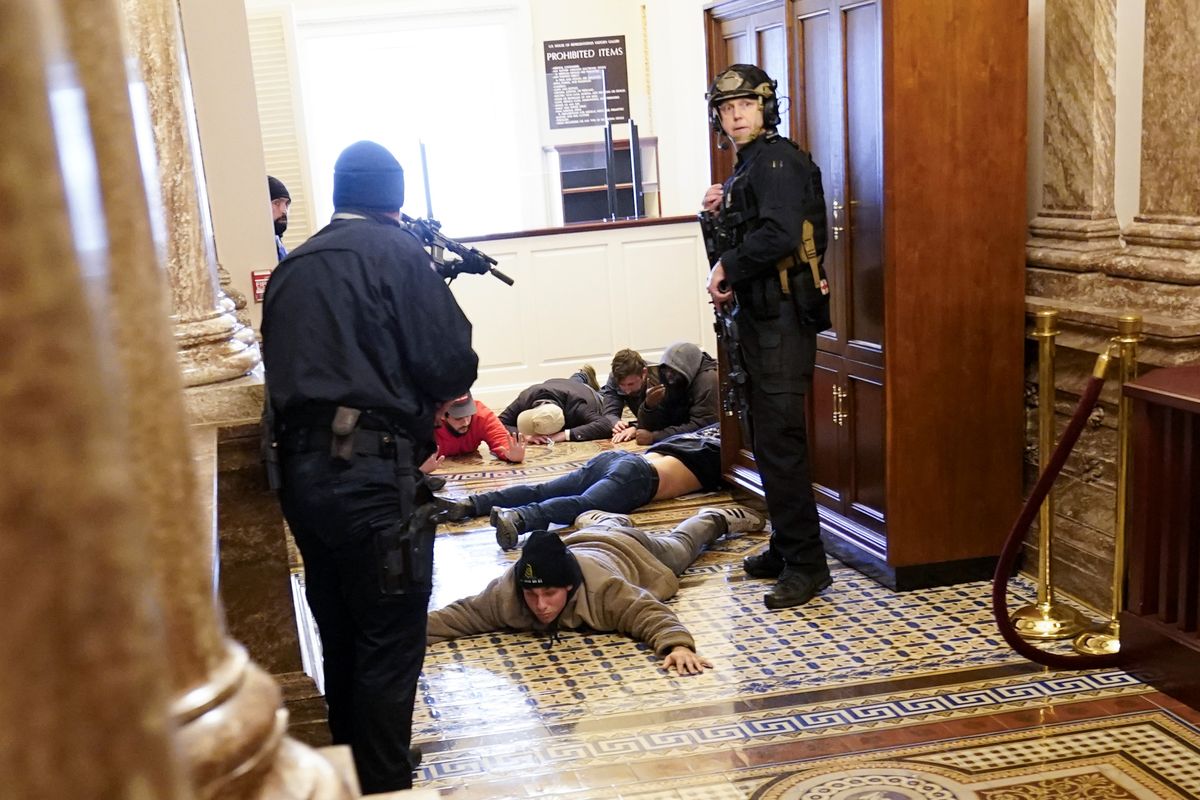 U.S. Capitol Police hold rioters at gun-point near the House Chamber inside the U.S. Capitol on Wednesday, Jan. 6, 2021, in Washington.  (Andrew Harnik)