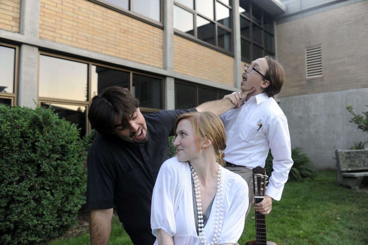 Lucentio, played by Jacob Moore, left, tries to charm Bianca, played by Brigid Carey, while holding off would-be suitor Hortensio, played by Justin Leedy, right, in rehearsal of the Way Off Broadway Company production of “The Taming of the Shrew” last week  at Gonzaga Prep. (PHOTOS BY JESSE TINSLEY / The Spokesman-Review)