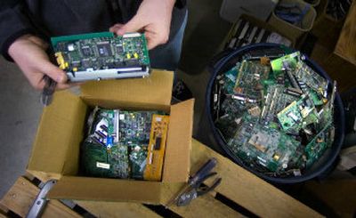 Dennis Ford goes through packages of circuit boards mailed recently to his Inland Retech business from Wenatchee. Inland Retech is one of the main companies in the Spokane area that will recycle and resell old electronic equipment.
(File Photo / The Spokesman-Review)