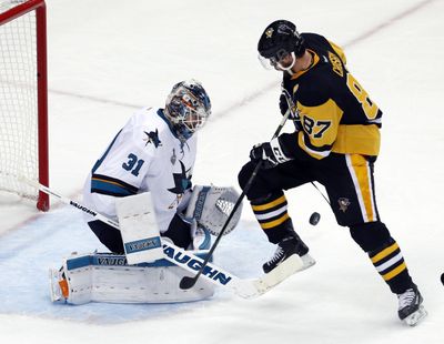 San Jose Sharks goalie Martin Jones defends as Pittsburgh’s Sidney Crosby  attempts to control the puck during the second period of Game 5 on Thursday in Pittsburgh. (Gene J. Puskar / Associated Press)