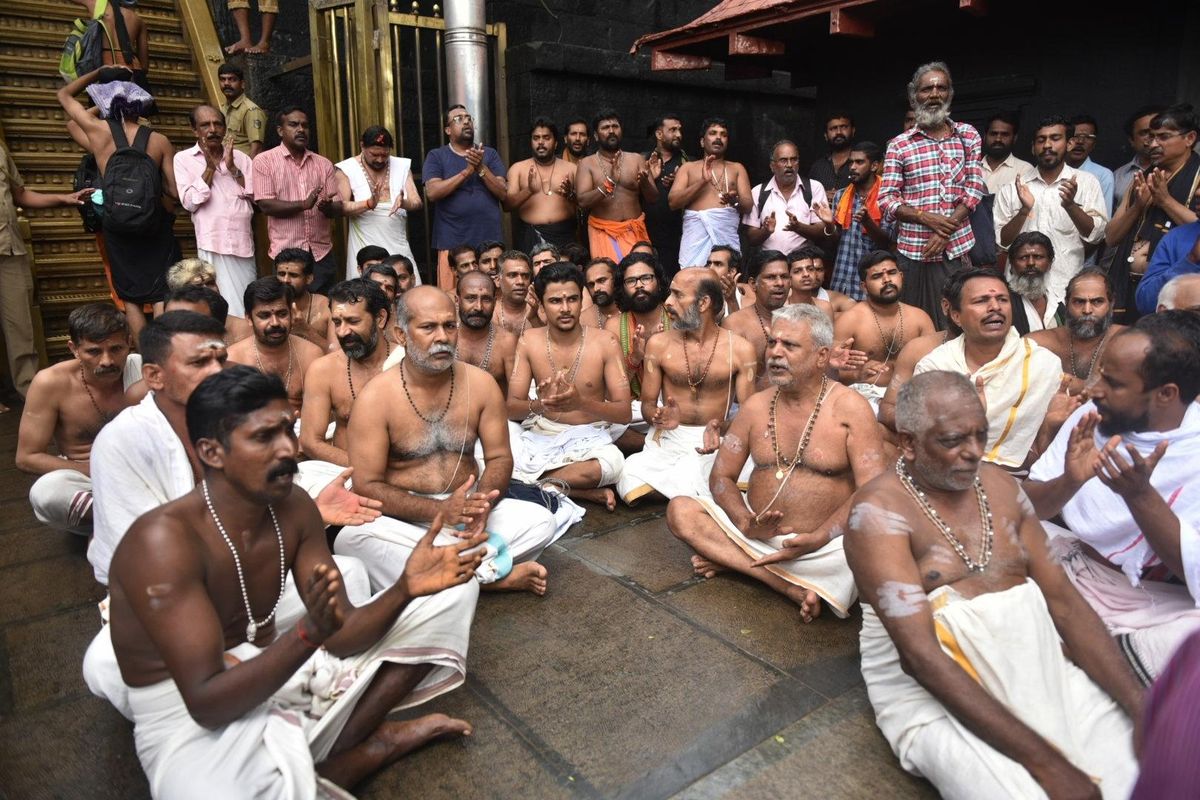 Hindu priests and temple staff sit on a protest against a ruling from India’s top court to let women of menstruating age entering Sabarimala temple, one of the world’s largest Hindu pilgrimage sites, in the southern Indian state of Kerala, Friday, Oct. 19, 2018. The country’s Supreme Court had on Sept. 28, lifted the temple’s ban on women of menstruating age, holding that equality is supreme irrespective of age and gender. Two young women, a journalist and an activist, were forced to turn back after they had reached the temple precincts under a heavy police escort. (AP)