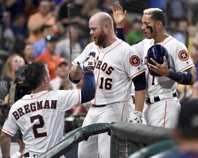 Houston Astros’ Brian McCann (16) celebrates his solo home run off Seattle Mariners starting pitcher Hisashi Iwakuma with Alex Bregman (2) and Carlos Correa, right, during the third inning of a baseball game, Tuesday, April 4, 2017, in Houston. (Eric Christian Smith / Associated Press)