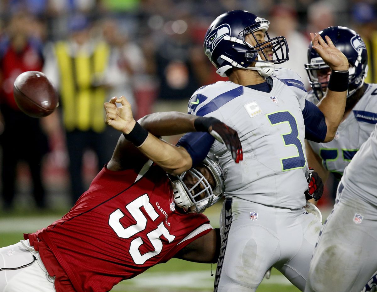 Arizona Cardinals outside linebacker Chandler Jones (55) forces Seattle Seahawks quarterback Russell Wilson (3) to fumble during the second half of Sunday’s game. The Seahawks recovered and were forced to punt. (Ross D. Franklin / Associated Press)
