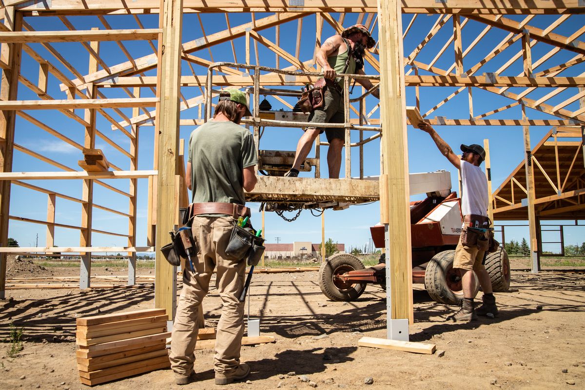 Construction workers build a structure at a job site off of Deer Heights Road near Airway Heights in June. The Washington state Department of Labor and Industries on Wednesday filed emergency heat and wildfire rules to protect outdoor workers this summer.  (Libby Kamrowski/The Spokesman-Review)