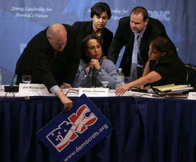 
Democratic National Committee Rules and Bylaws Committee co-chairman Jim Roosevelt, left, tries to fix a fallen sign as co-chairwoman Alexis Herman, second from left, Patrice Taylor, center, Phil McNamara and Stacie Paxton, right, try to help during Saturday's meeting in Washington. Associated Press
 (Associated Press / The Spokesman-Review)