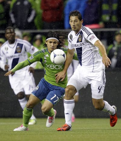 Seattle’s Fredy Montero, left, zeroes in on the ball. (Associated Press)