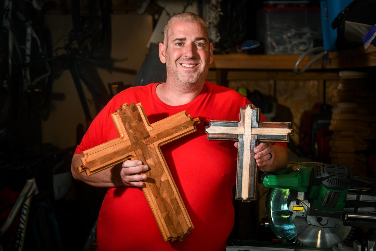 Scott Hendricks, 44, was diagnosed with brain cancer in June 2019. Unable to work or drive he began making wooden crosses in his shop in November 2020 and giving them to people.  (Dan Pelle/THESPOKESMAN-REVIEW)