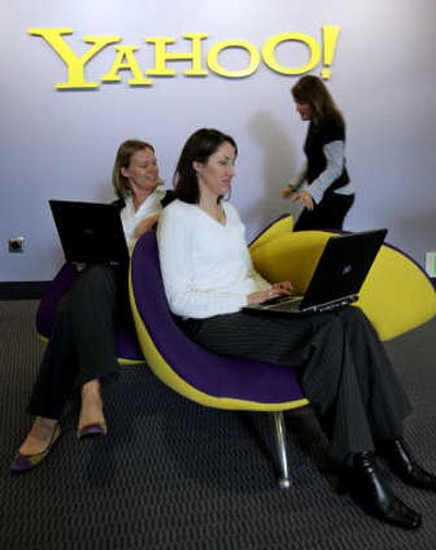 
Yahoo Inc. employees Nicole Leverich, left, and Terrell Karlsten, center,  work  at company headquarters in Sunnyvale, Calif.,  in January  2006. The company on Tuesday said its third-quarter earnings declined slightly.Associated Press
 (File Associated Press / The Spokesman-Review)