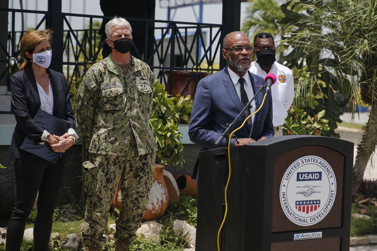 Haitian Prime Minister Ariel Henry speaks during a joint press conference with USAID and SOUTHCOM at the international airport in Port-au-Prince, Haiti,Thursday, Aug. 26, 2021, weeks after the 7.2 magnitude earthquake. At left are USAID Administrator Samantha Power and SOUTHCOM Commander Admiral Faller.  (Joseph Odelyn)