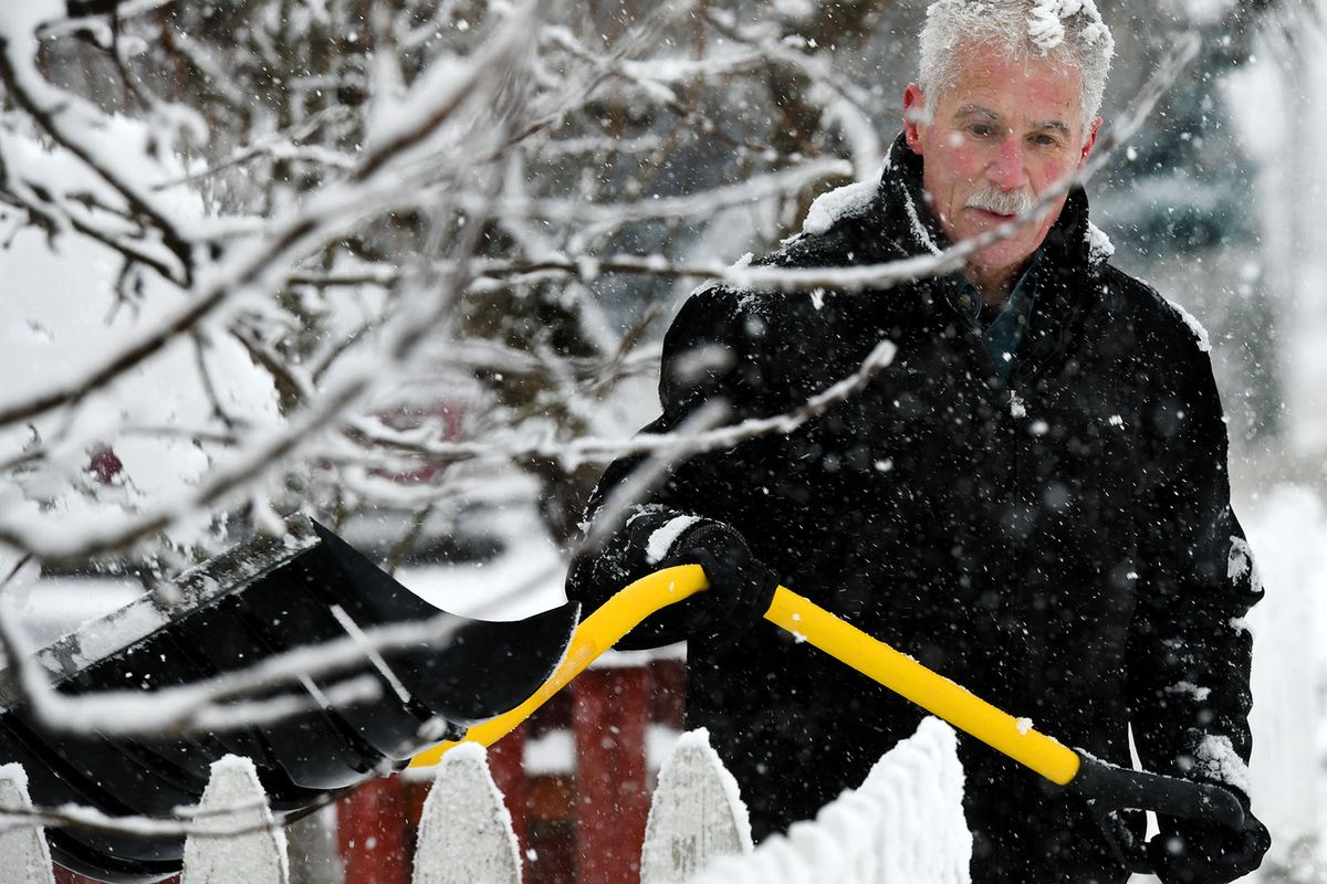 David Brown, of Post Falls, shovels his driveway as snow falls on Thursday.   (Kathy Plonka/The Spokesman-Review)