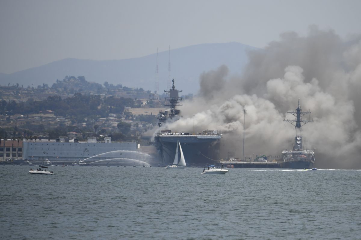 Smoke rises from the USS Bonhomme Richard at Naval Base San Diego Sunday, July 12, 2020, in San Diego after an explosion and fire Sunday on board the ship at Naval Base San Diego.  (Denis Poroy)