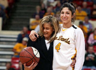 
ASU coach Charli Turner Thorne, left, presents Emily Westerberg, right, an award for scoring 1,000 career points before the game. 
 (Associated Press / The Spokesman-Review)