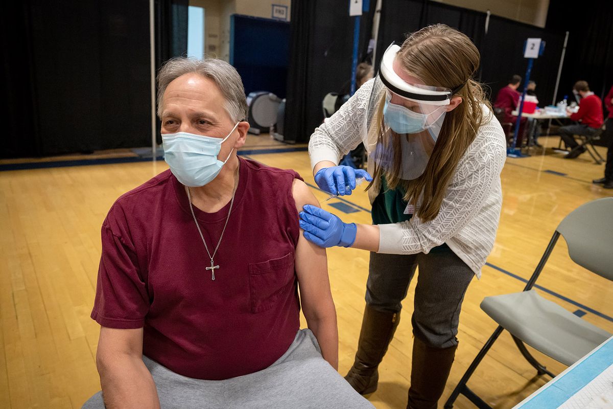 William Peterson receives his first dose of the Moderna COVID-19 vaccine from WSU pharmacy student Madi Kissinger at a Chas Health vaccination clinic set up in Gonzaga’s Martin Centre, Friday, Feb. 26, 2021. CHAS Health is hosting COVID-19 vaccine clinics over the next few days for community members who qualify for the vaccine in Phase 1A and 1B under Washington State. As a federally qualified heath center, CHAS Health was chosen to receive a delivery of federal supply doses of COVID-19 vaccines to serve their patient population. This initial delivery was larger than could be managed through CHAS Health’s clinic locations without adversely impacting other patient care. CHAS Health reached out to Gonzaga University about the use of one of our large areas to efficiently and effectively distribute this vaccine to their patients while maintaining proper social distancing. (COLIN MULVANY/THE SPOKESMAN-REVIEW)