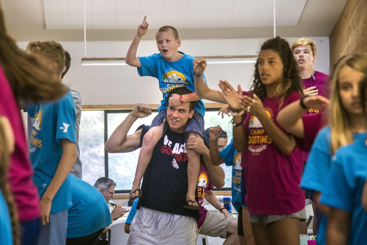 Levi Aden, 9, gets a lift from Gonzaga University basketball player Corey Kispert as they shout out “GO GONZAGA” during a dance party, July 11, 2017, at Camp Goodtimes. Nine GU student-athletes volunteer their time to visit the campers, their siblings and friends, who are affected by a cancer diagnosis. (Dan Pelle / The Spokesman-Review)