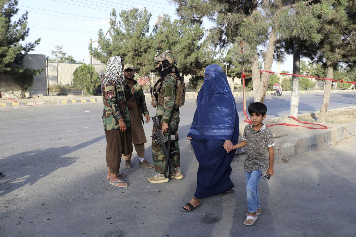 Taliban fighters stand guard at a checkpoint near the gate of Hamid Karzai international Airport in Kabul, Afghanistan, Saturday, Aug. 28, 2021. The Taliban have sealed off Kabul’s airport to most would-be evacuees to prevent large crowds from gathering after this week's deadly suicide attack. The massive U.S.-led airlift was winding down Saturday ahead of a U.S. deadline to withdraw from Afghanistan by Tuesday.  (Wali Sabawoon)