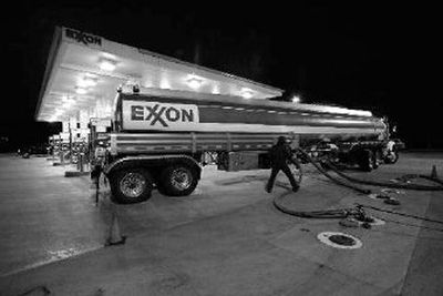 
A worker delivers fuel to an Exxon station in Keller, Texas, last week. Exxon Mobil Corp. on Thursday posted the largest annual profit by a U.S. company, $39.5 billion. The number topped the previous record of $36.13 billion which Exxon set in 2005.
 (Associated Press / The Spokesman-Review)