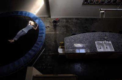 
Julie Elaine Koesel relaxes on the full-size trampoline in her downtown condo.  Koesel also runs her skin care business, Julie Elaine, from the residence.
 (Jed Conklin / The Spokesman-Review)