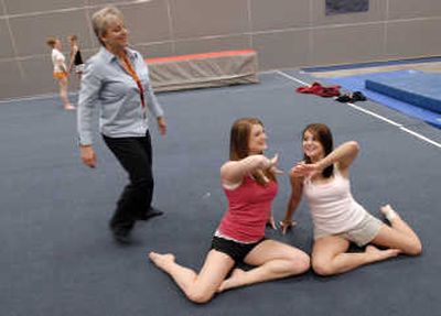 
University High School gymnastics coach Tracy Duncan shares a light moment as she works with her senior captains Tracy Vold and Tatiana Garcia at practice Monday. 
 (J. BART RAYNIAK / The Spokesman-Review)