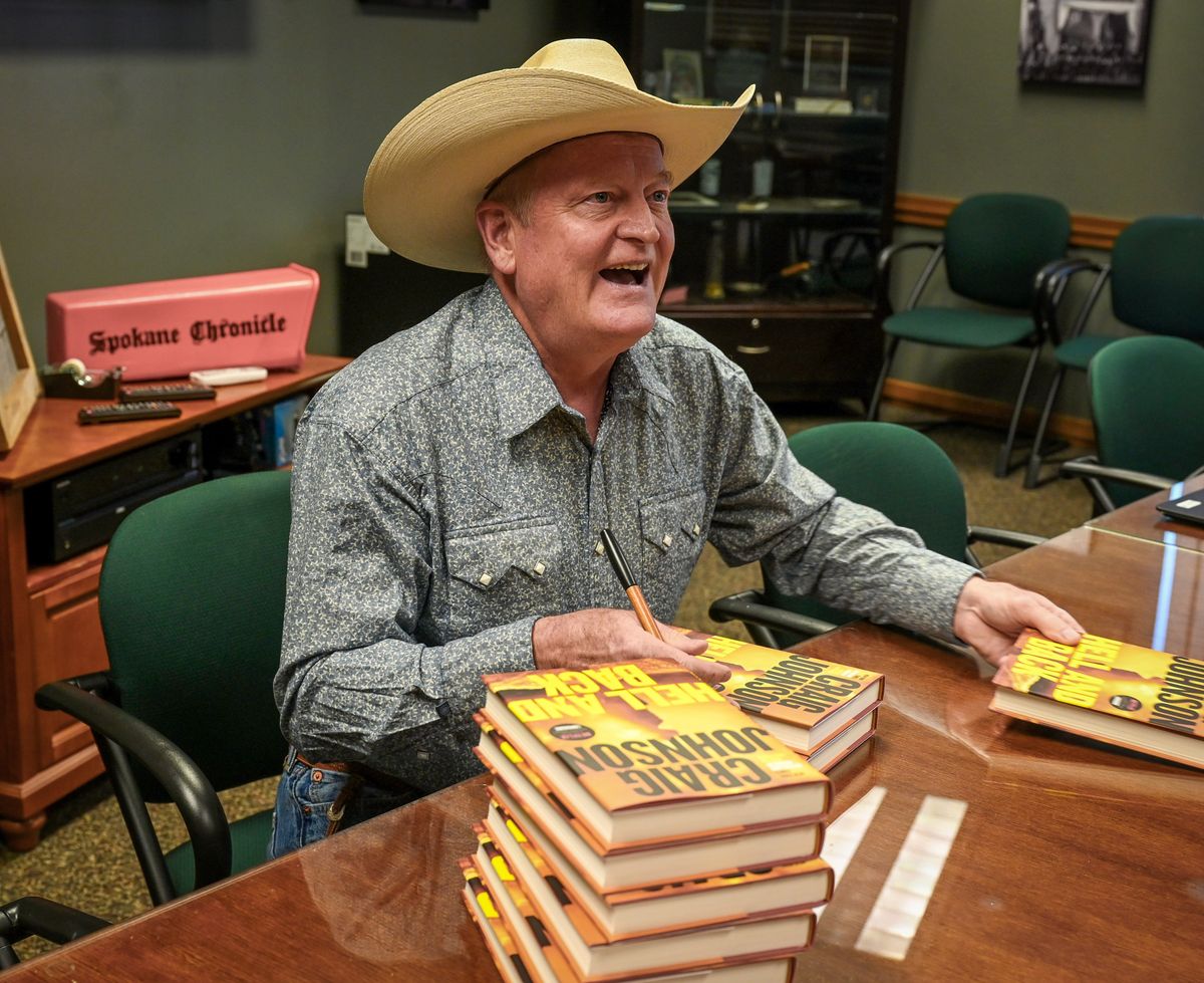 "Longmire" author Craig Johnson returns to Northwest Passages with the latest installment in the series, "Hell and Back." Here Johnson signs his books before going to the Bing Crosby Theater Saturday, Sept. 17, 2022. Johnson is the New York Times bestselling author of the Longmire mysteries, the basis for the hit Netflix original series Longmire. He is the recipient of the Western Writers of America Spur Award for fiction, the Mountains and Plains Booksellers Award for fiction, the Nouvel Observateur Prix du Roman Noir, and the Prix SNCF du Polar.  (DAN PELLE/THE SPOKESMAN-REVIEW)