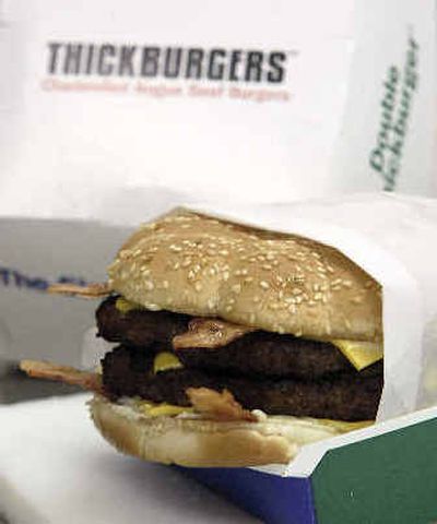 
A Hardee's Monster Burger is shown in the CKE test kitchen. The Monster Burger and the other thick burgers in Hardee's lineup are the main reason for the company's resurgence. 
 (Associated Press photos / The Spokesman-Review)