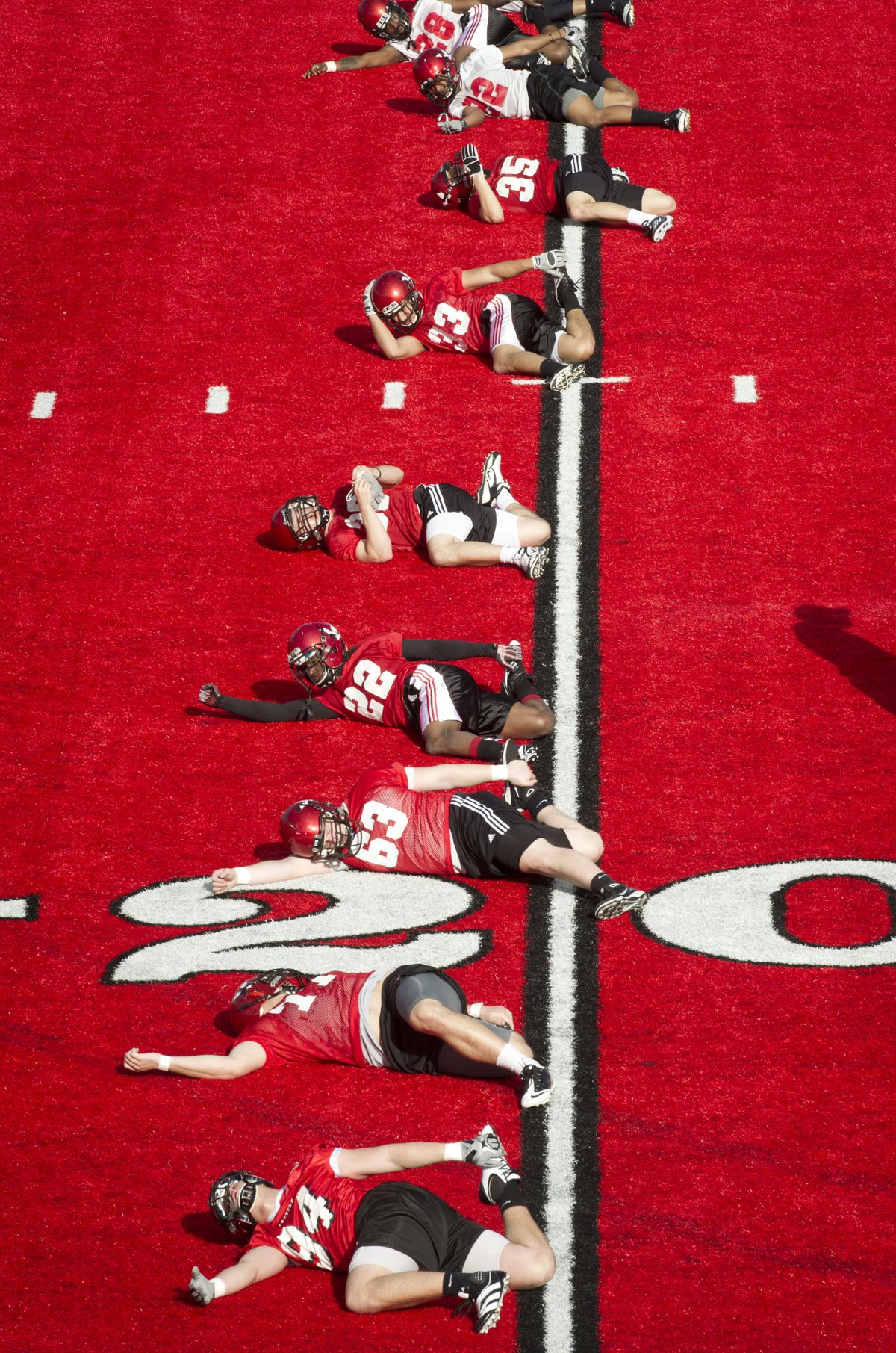Eastern players stretch out before their first spring practice Tuesday at Roos Field. (Colin Mulvany)