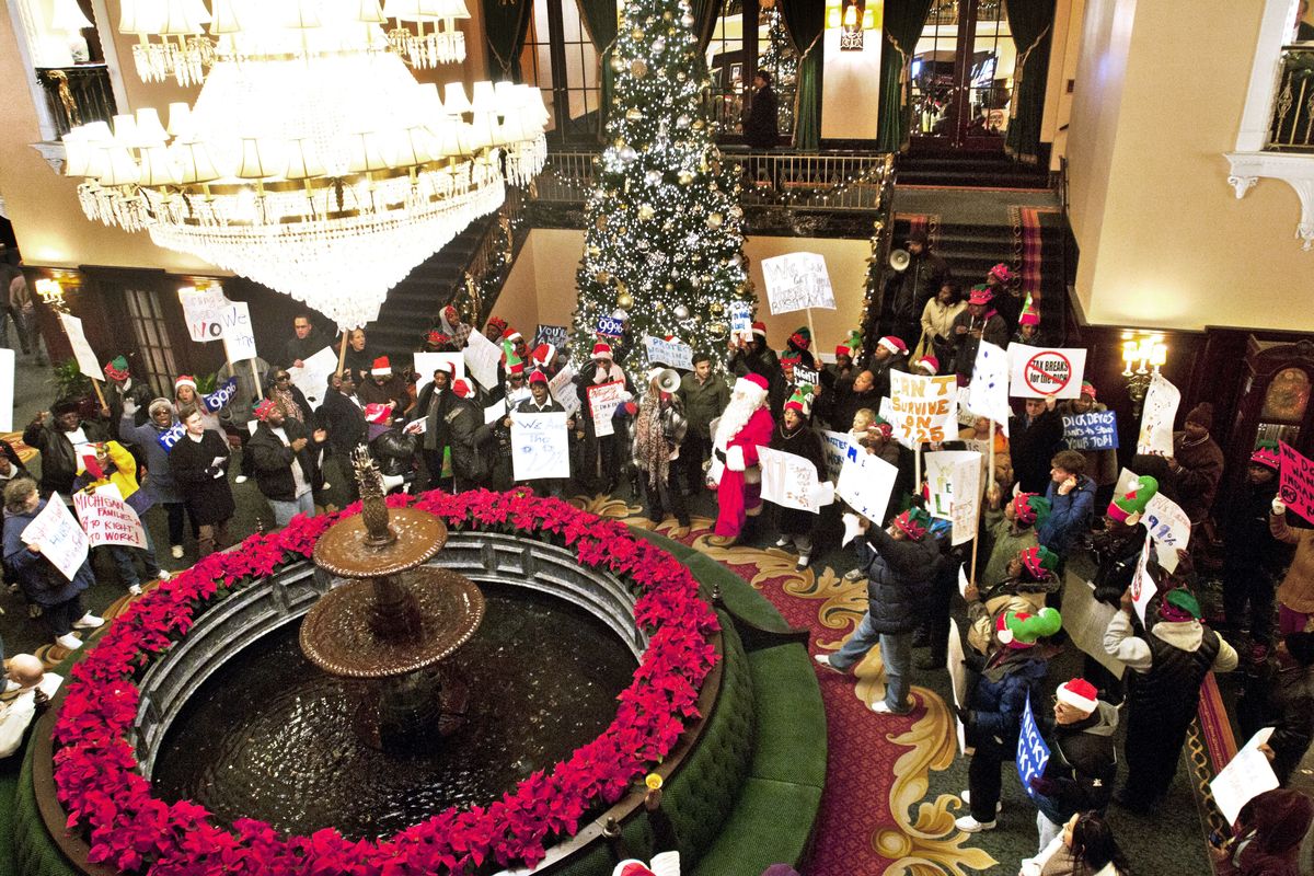A group of demonstrators inside the Amway Grand Plaza Hotel call for Dick DeVos to end financial support for right-to-work legislation, Wednesday, Dec. 5, 2012 in Grand Rapids, Mich. (Chris Clark / The Grand Rapids Press)