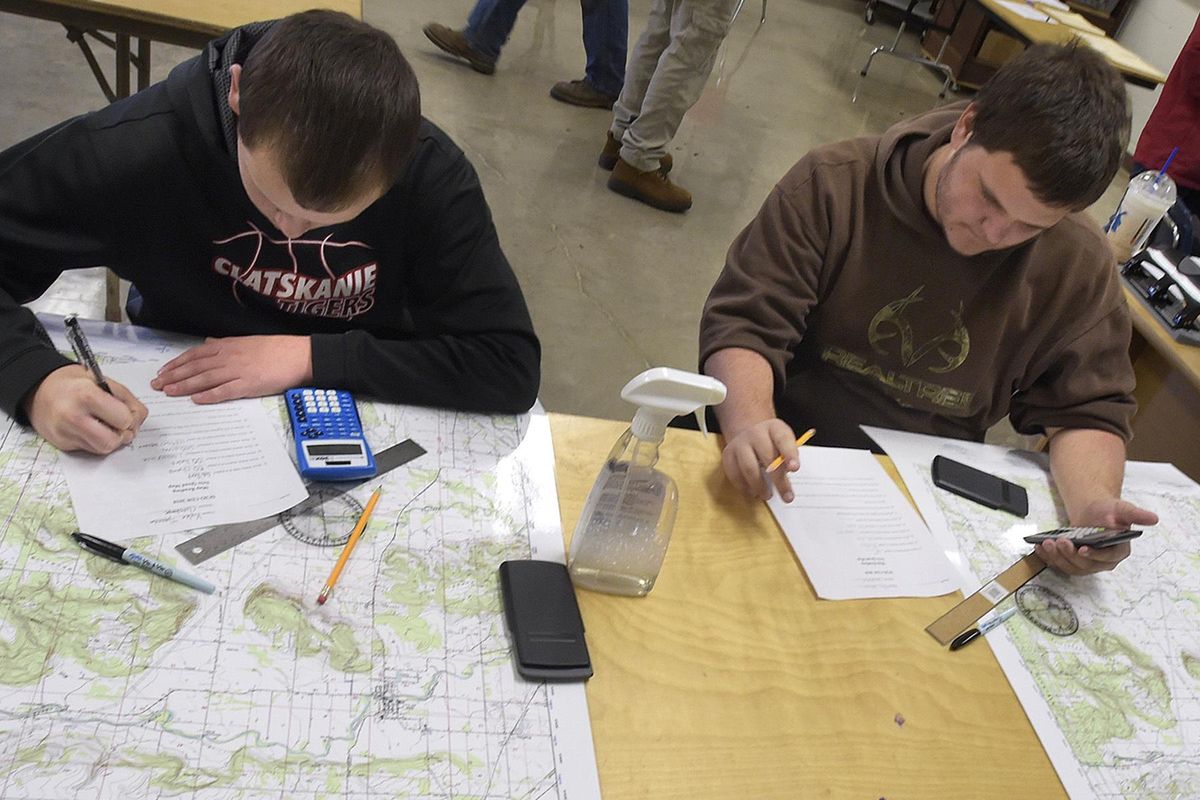 Kyler Tjaarda, 16, left, and Ethan Johnson, 17, both of Clatskanie, Ore., work on their map reading skills during one of the events at the Scio Forestry Competition on Thursday, Oct. 11, 2018, at Scio High School in Scio, Ore. (Mark Ylen / Albany Democrat-Herald)