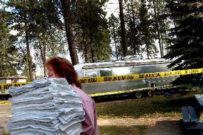
Arlene Mitzimberg had to walk around the yellow crime-scene tape on Monday to retrieve her mother's laundry from the laundromat at the Tamarack Mobile Home Park after two bodies were found in the Airstream trailer in the background in an apparent murder-suicide.
 (Kathy Plonka / The Spokesman-Review)
