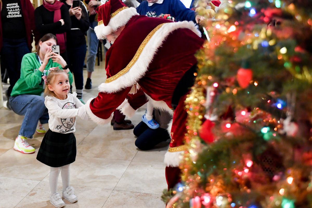 Ukranian refugee Emilia Miroshnyk reacts as she meets Santa on Thursday at Thrive in Spokane.  (Tyler Tjomsland/The Spokesman-Review)