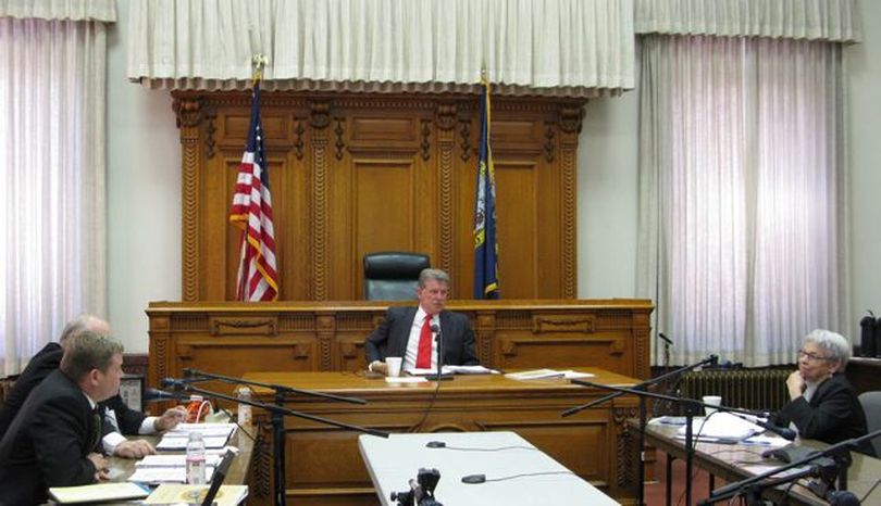 Gov. Butch Otter, center, presides over the Idaho Land Board on Tuesday; the board voted to give cabin owners on state-owned land at Priest Lake a two-year lease extension, though at higher rent, while two lawsuits over state cabin-site rents work their way through the courts. (Betsy Russell)