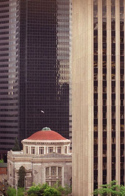
The First United Methodist Church is seen dwarfed by skyscrapers in  Seattle.  A  developer is buying the site of the downtown church.  Preservation advocates had hoped to save the 1907 building. 
 (Associated Press / The Spokesman-Review)