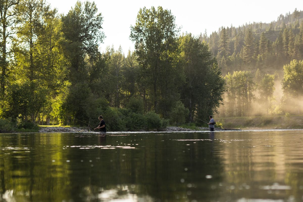 Tim Sperber, right, and son Dillon look to catch cutthroat trout on the St. Joe River shortly before dusk on Saturday, July 4, 2020, near Calder, Idaho.  (Madison McCord/The Spokesman-Review)