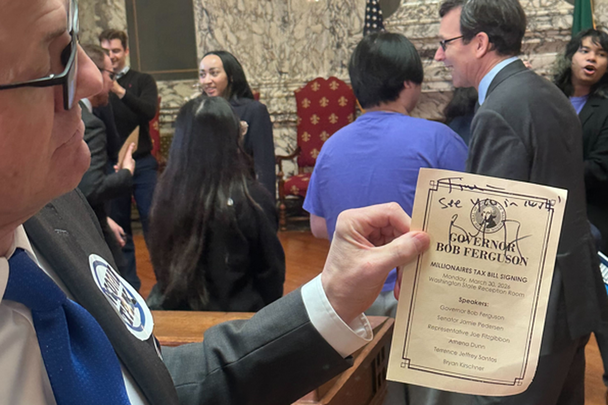 Anti-tax activist Tim Eyman holds up an itinerary for Monday