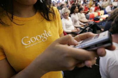 
A Google worker dials her cell phone at Google headquarters in Mountain View, Calif. Confirming its long-rumored foray into the mobile market, Google said Monday it is developing a free cell phone software package so it can send ads and services to people away from computers.Associated Press
 (Associated Press / The Spokesman-Review)