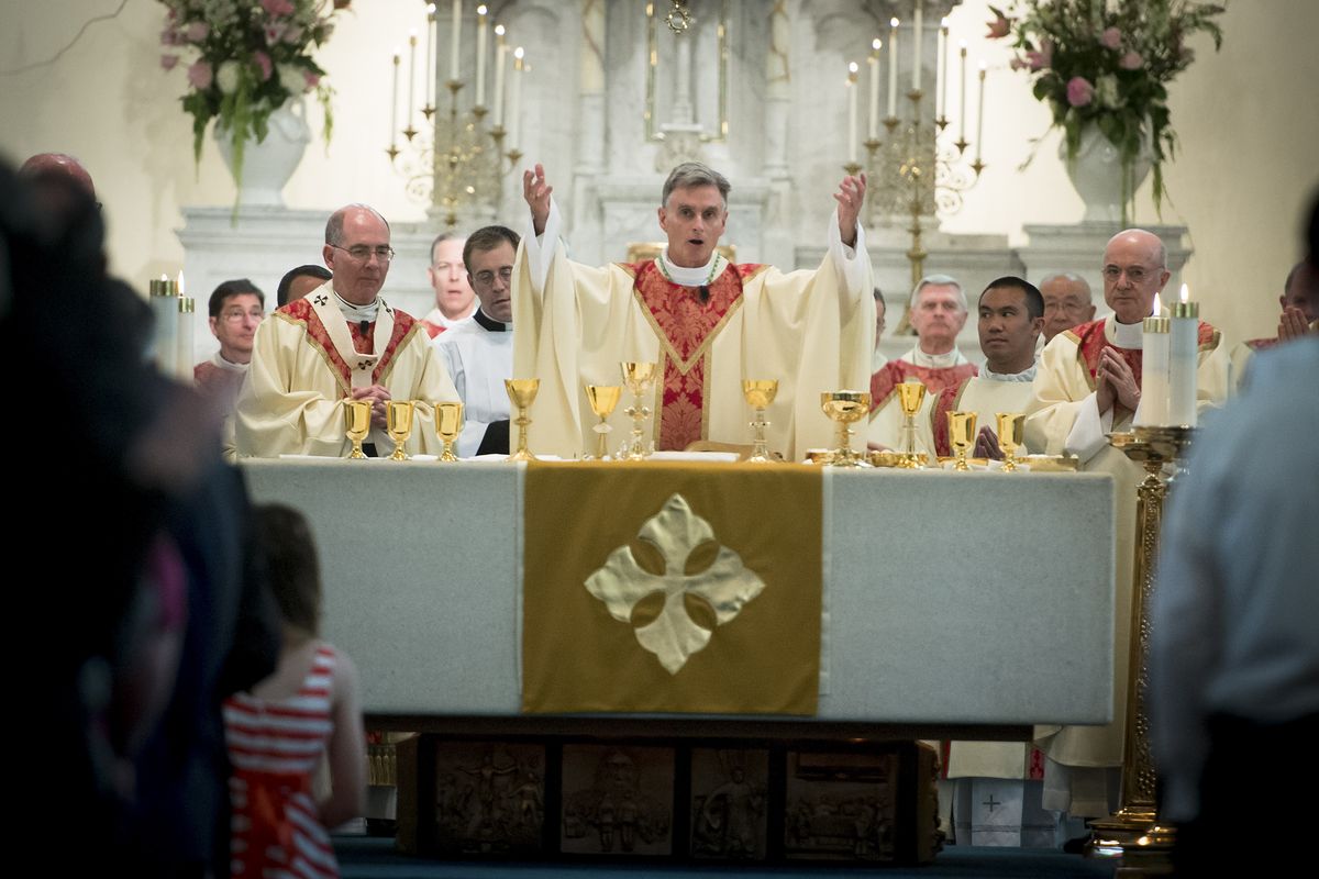 After being installed as seventh bishop of Spokane, the Most Rev. Thomas Daly prepares the gifts during the Liturgy of the Eucharist on Wednesday at the Cathedral of Our Lady of Lourdes in Spokane. Daly previously served in the San Francisco Bay Area. (Colin Mulvany)