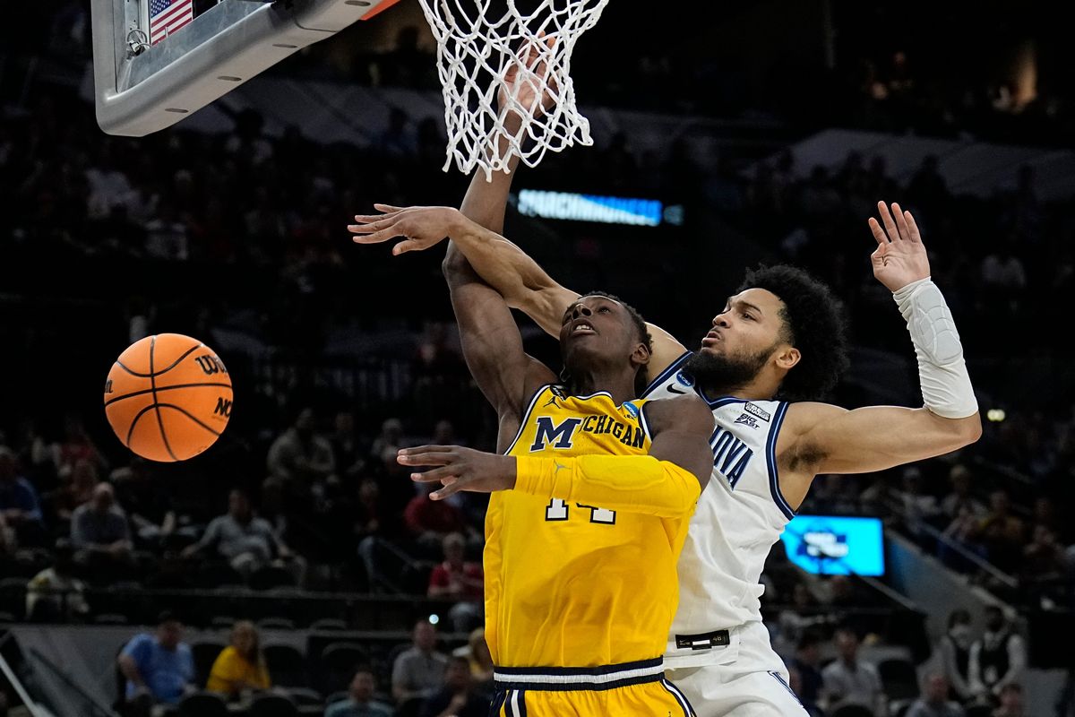 Villanova guard Caleb Daniels, right, fouls Michigan forward Moussa Diabate during the second half of a college basketball game in the Sweet 16 round of the NCAA tournament on Thursday, March 24, 2022, in San Antonio.  (Eric Gay)