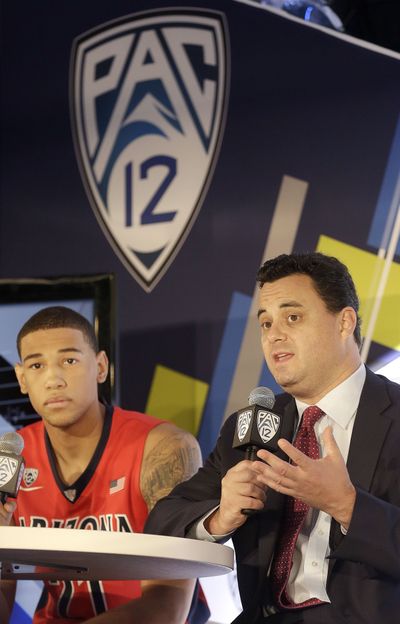 Arizona, with forward Brandon Ashley, left, and head coach Sean Miller, is the overwhelming favorite to win the Pac-12 Conference. (Associated Press)