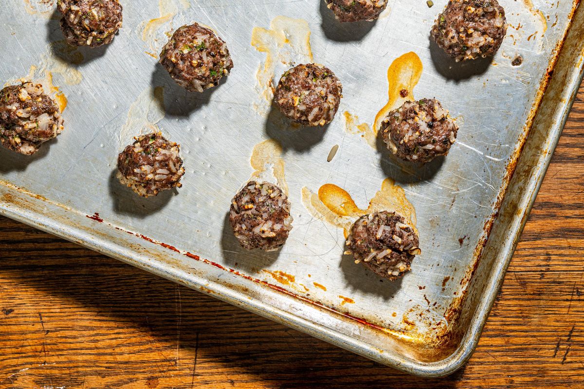 Lamb meatballs with sumac and feta are pungent with spring onions and lemony sumac.  (Rey Lopez/For the Washington Post)