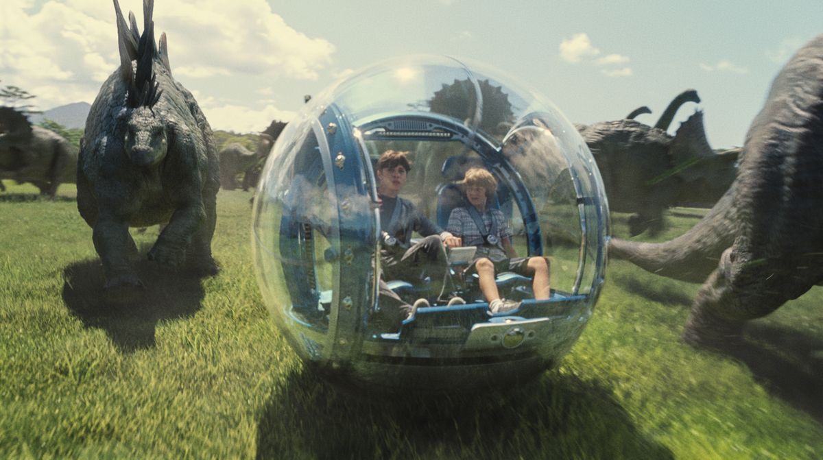 Nick Robinson, left, as Zach, and Ty Simpkins as Gray, star in a scene from the film “Jurassic World.”